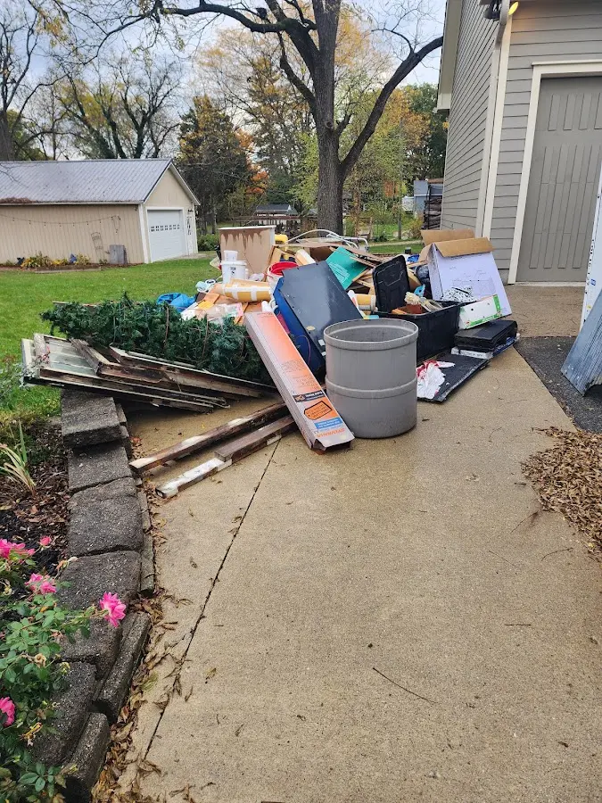 Dumpster being loaded with debris for Roofing Dumpster Rental in Creedmoor
